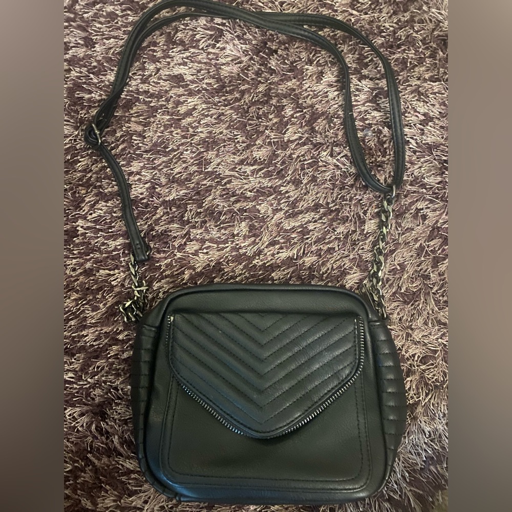 Black leather purse with front pocket, chain and leather strap